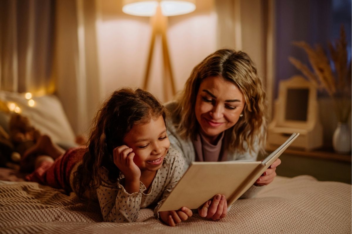 Mother and young child sharing a story together at home, an example of intergenerational storytelling.